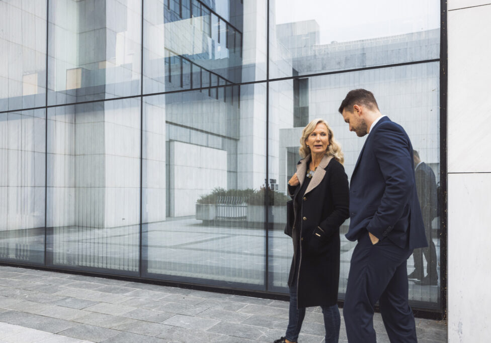 a-female-leader-walks-in-front-of-an-office-buildi-2026-01-07-06-46-13-utc