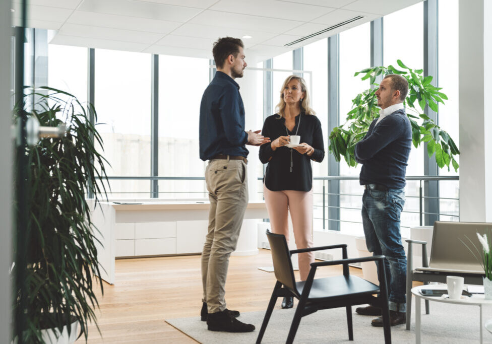 group-of-three-business-people-standing-in-a-moder-2026-01-07-06-45-56-utc